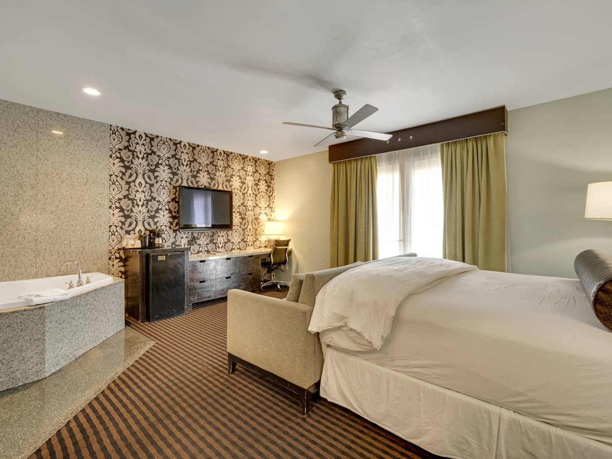 Poolside Suite - Bed, tub, and amenities view